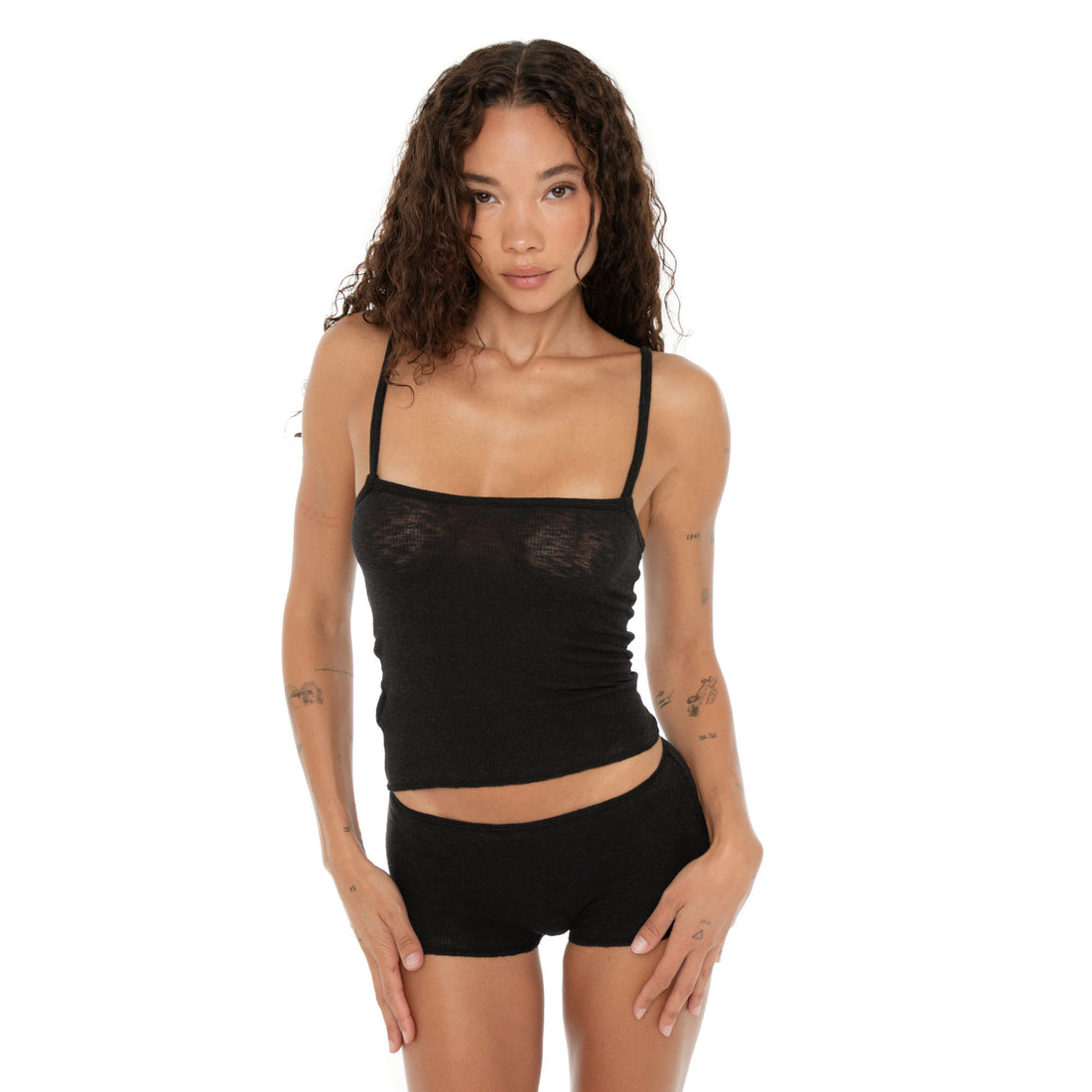 Front-facing close-up of the Aili Short in black, model standing with hands resting on thighs. **black