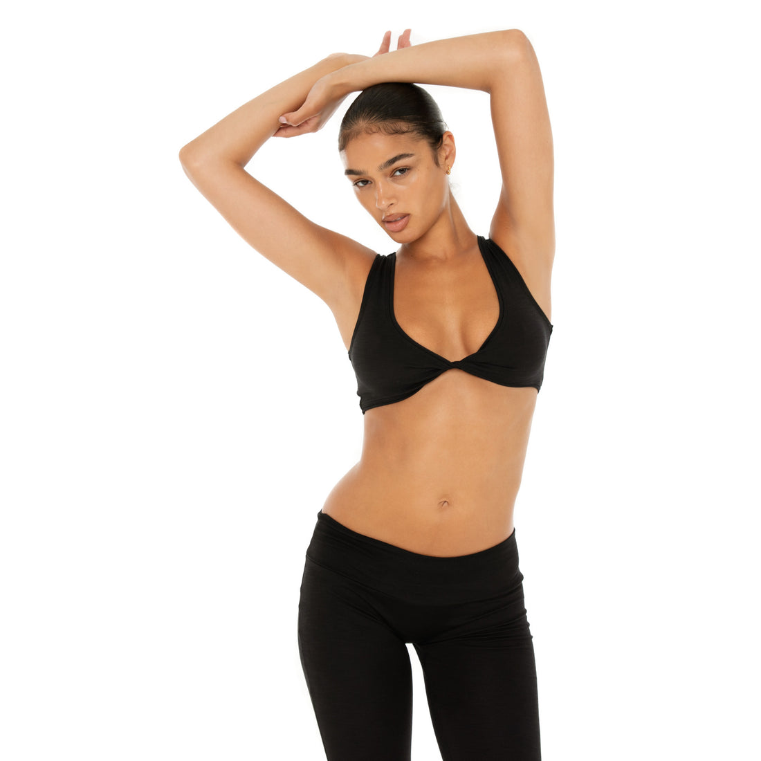 Alue Top in black with twist front detail and AYAI blue logo accents **black