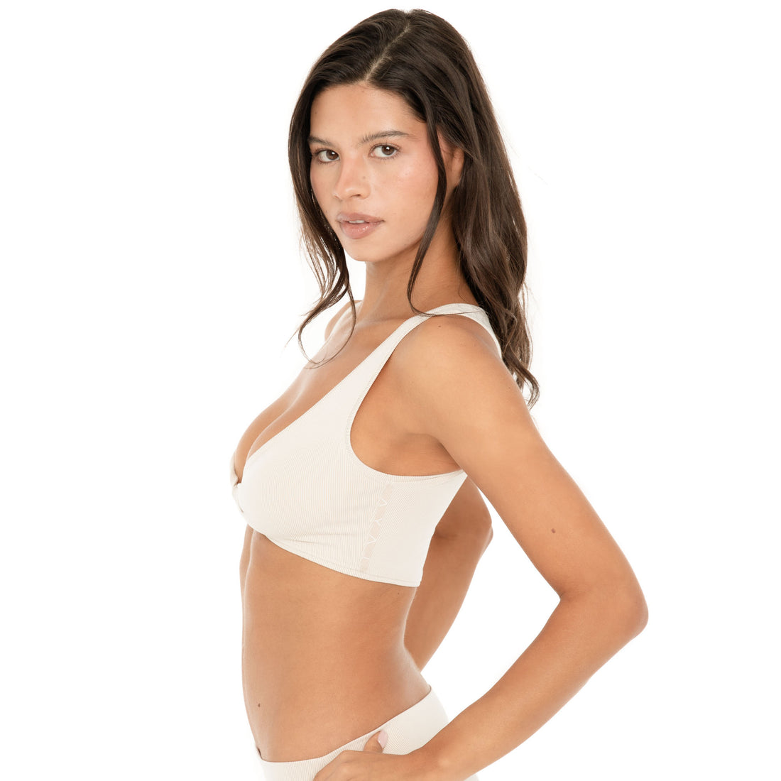 Side view: Side view of the sand Alue Top, showing the fitted cropped silhouette, wide straps, ribbed fabric, and lace-up detail at the side **sand
