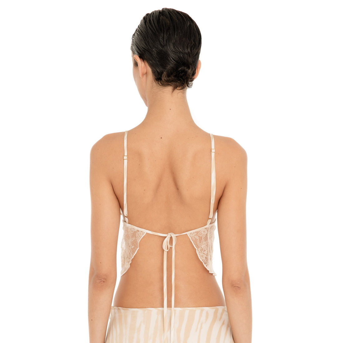 Back view of the Are You Am I Aria Camisole in Ivory Latte, featuring lace side panels, adjustable shoulder straps and an open back with a tie closure. **ivory-latte