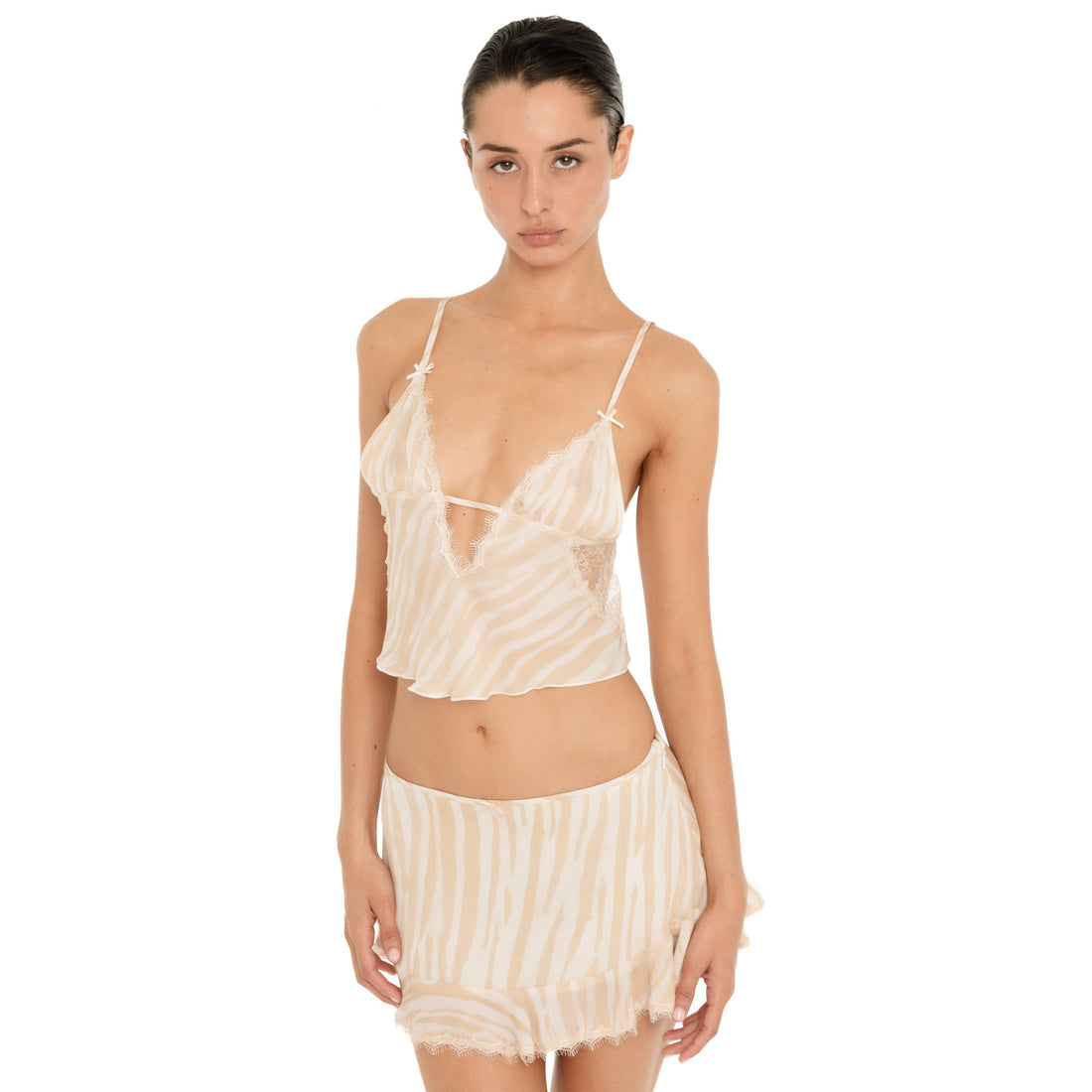 Model wearing the Are You Am I Aria Camisole in Ivory Latte with the matching skirt, showing the sheer zebra print, lace-trim neckline and cropped silhouette. **ivory-latte