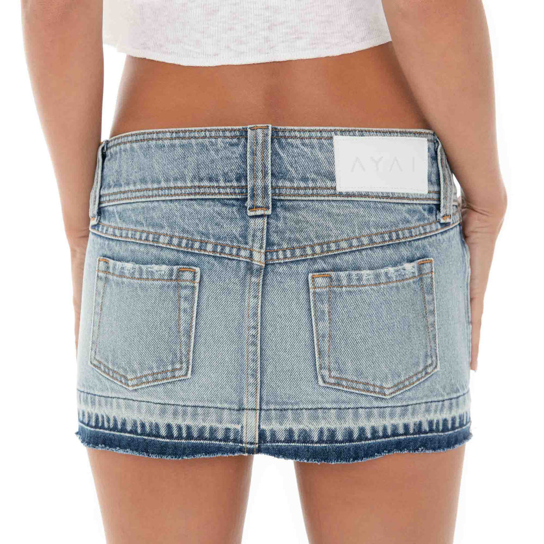 Are You Am I - Close-up of the Kynli Skirt’s back waistband showing the AYAI patch, classic denim pockets, and contrast fading for a worn-in, vintage effect.