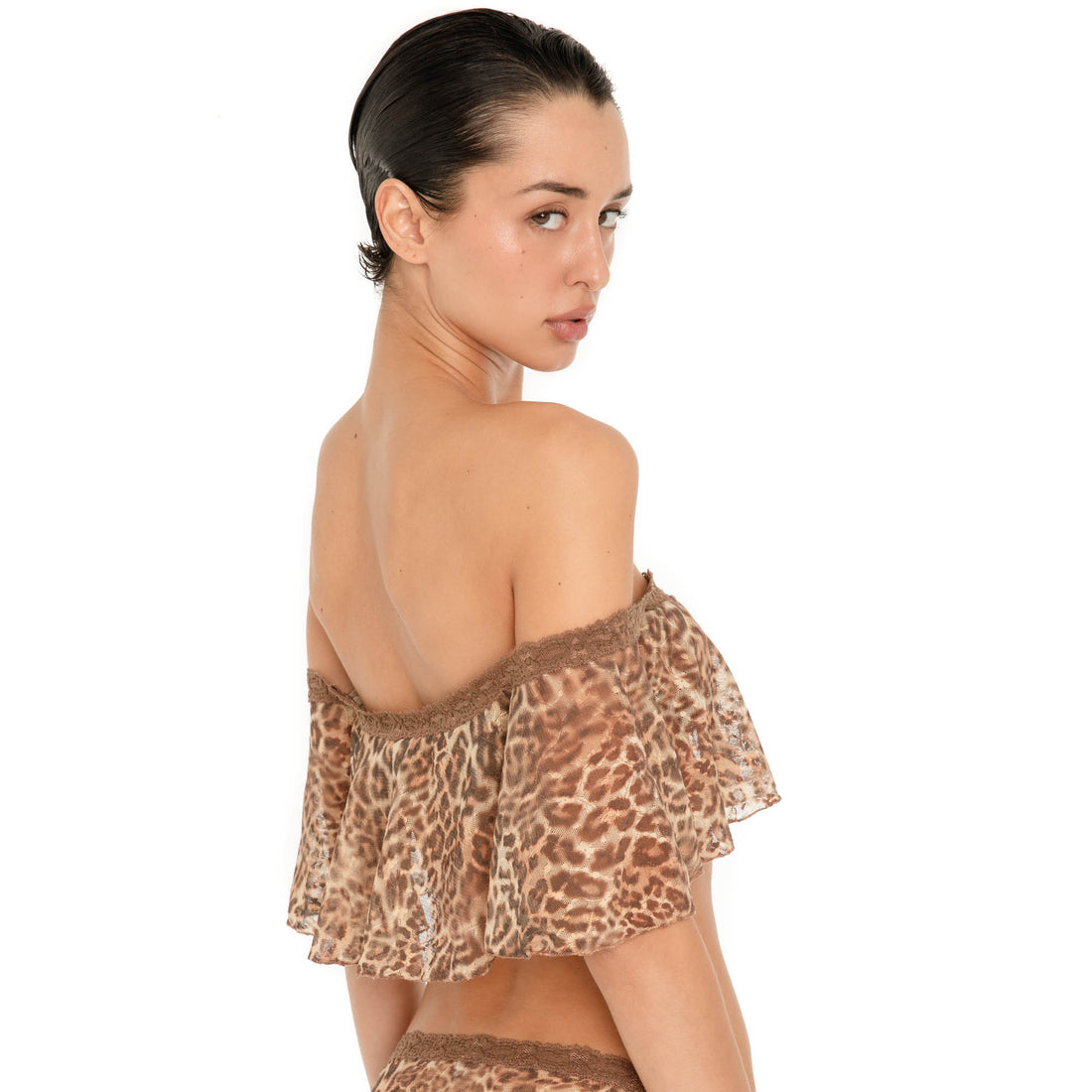 Close back three quarter view of the Liulu Leopard Top, showing the off shoulder fit, lace trimmed neckline and sheer leopard print ruffle draping across the back