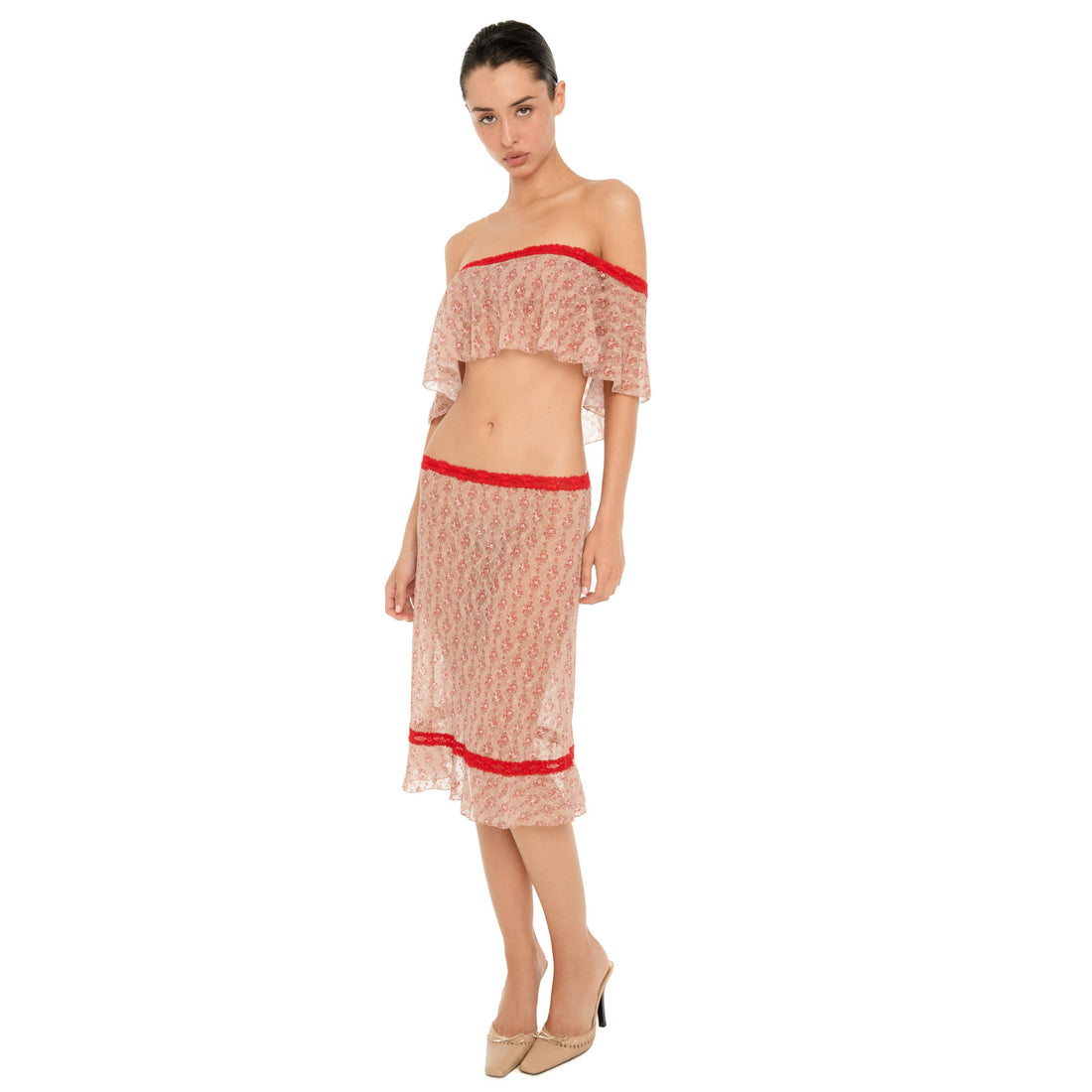 Full-length front three-quarter view of a model wearing the Cherry Blossom Liulu Skirt, showing its fitted sheer floral lace silhouette, contrasting red lace trim, and ruffled hem. **cherry blossom