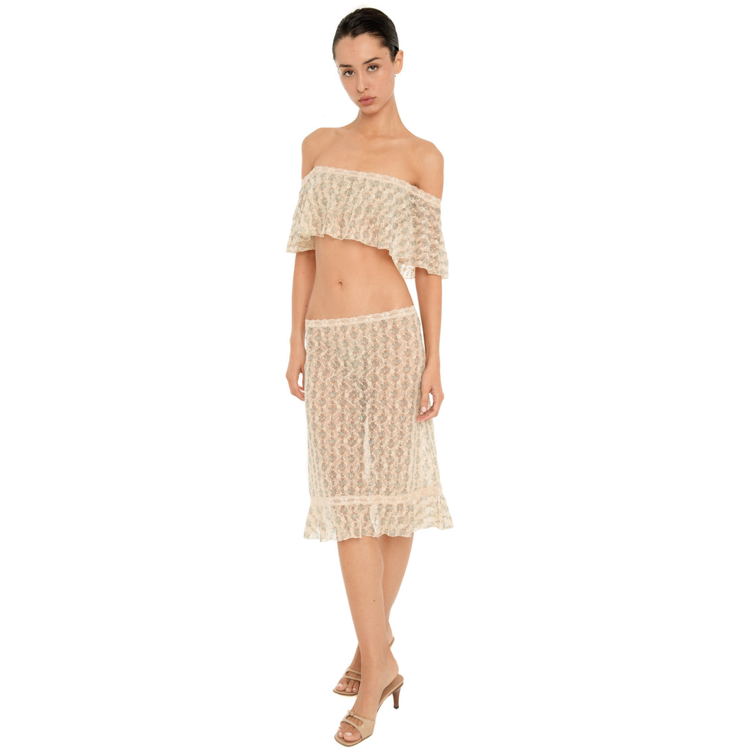 Front view of the Liulu skirt, featuring sheer floral lace, a fitted low-rise silhouette, delicate lace waistband, and ruffled midi hem. **sky blossom