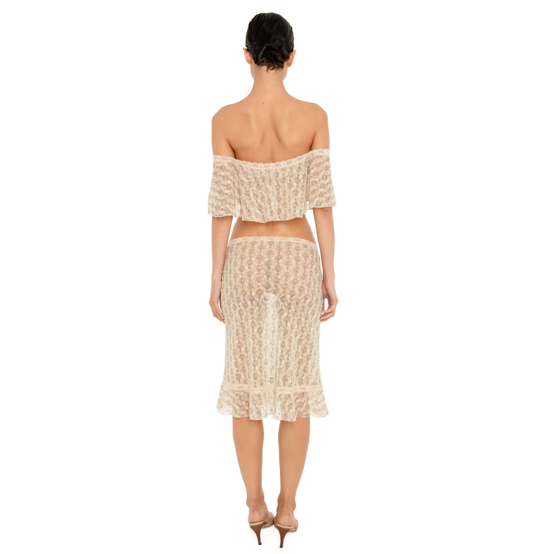 Back view of the Liulu skirt, a sheer cream floral lace midi skirt with a low-rise fit, lace waistband, and ruffled hem. **sky blossom
