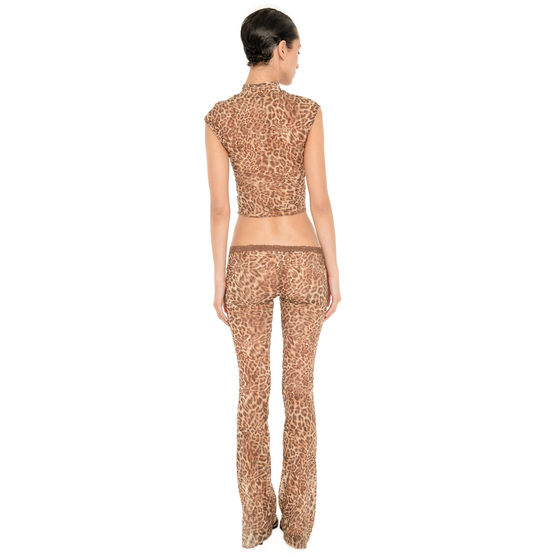 Back view of the Liani Pant in Leopard, showing the sheer leopard fabric, lace-trimmed waistband and flared silhouette.