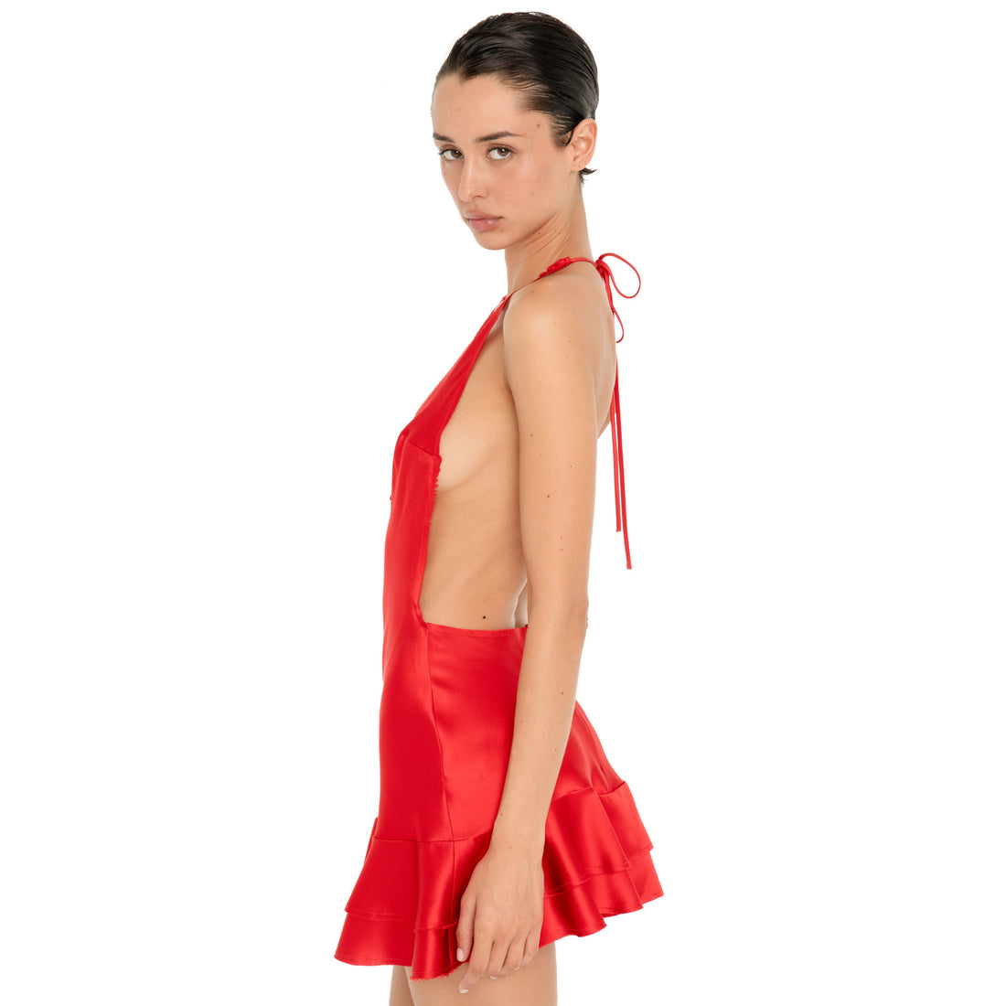 Side view of the cherry red Atalanta Dress showing the open side, halter ties and layered ruffle mini skirt. **cherry red
