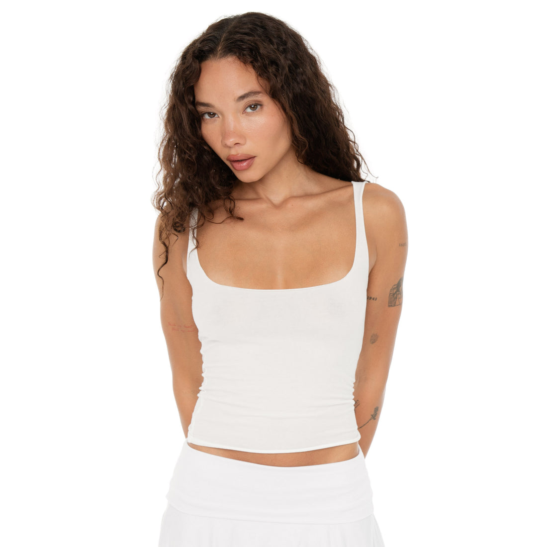 Close-up of Elix Tank white, minimal raw-edge neckline and seamless fit. **white