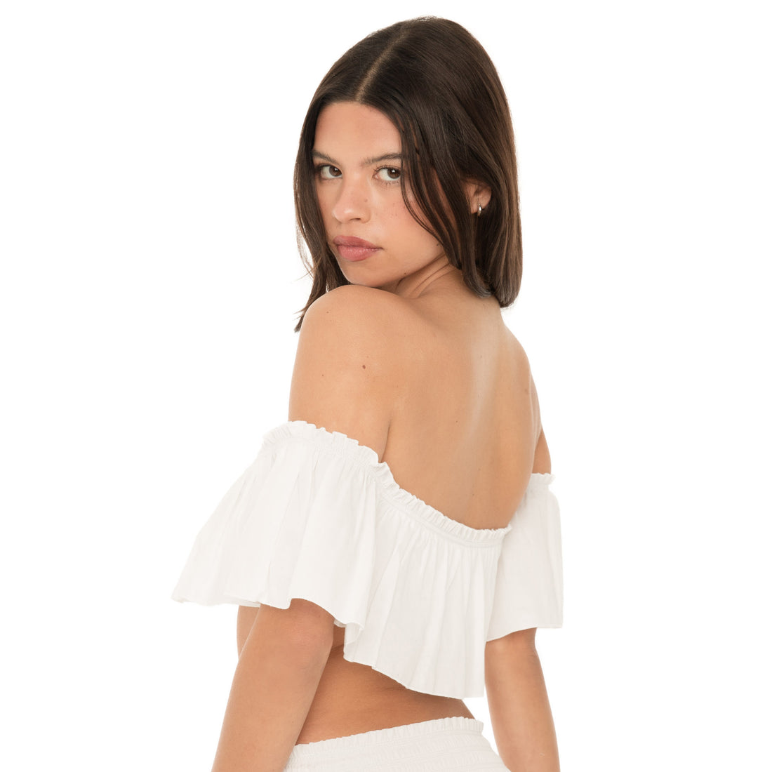 Back view of the white ruffle bandeau worn off the shoulders, showing the straight back neckline and flowing ruffle overlay.