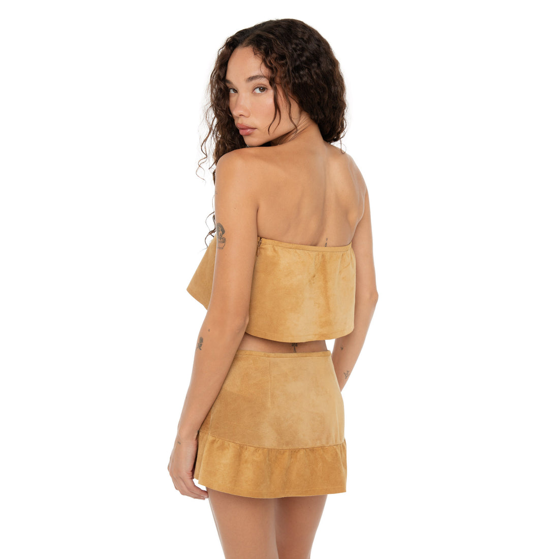 Back view highlighting the clean lines and zip closure of the Etra Top and Skirt **butterscotch