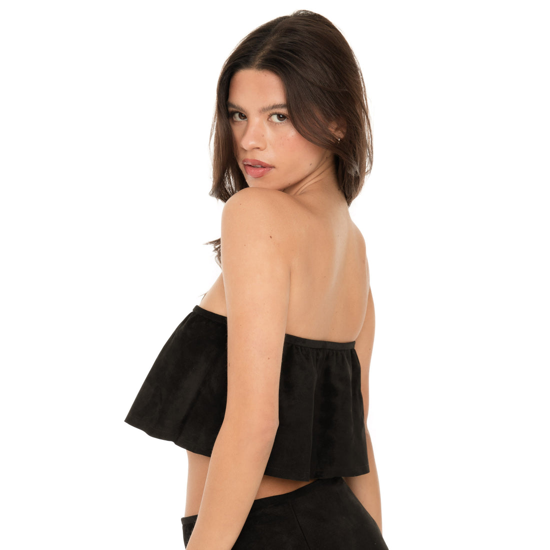 Side view of the Etra Top in black suede, featuring the discreet side zipper and gently undulating fold-over design. ** black