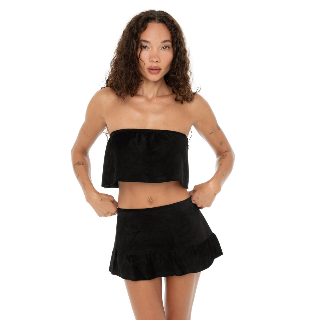 Model facing forward adjusting the top, showing wide drape and side zip fit. **black