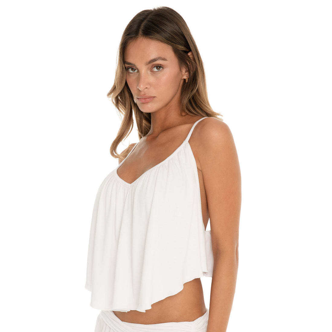 Side view of white cropped swing cami top highlighting fluid drape, lightweight fabric, and adjustable strap construction **white