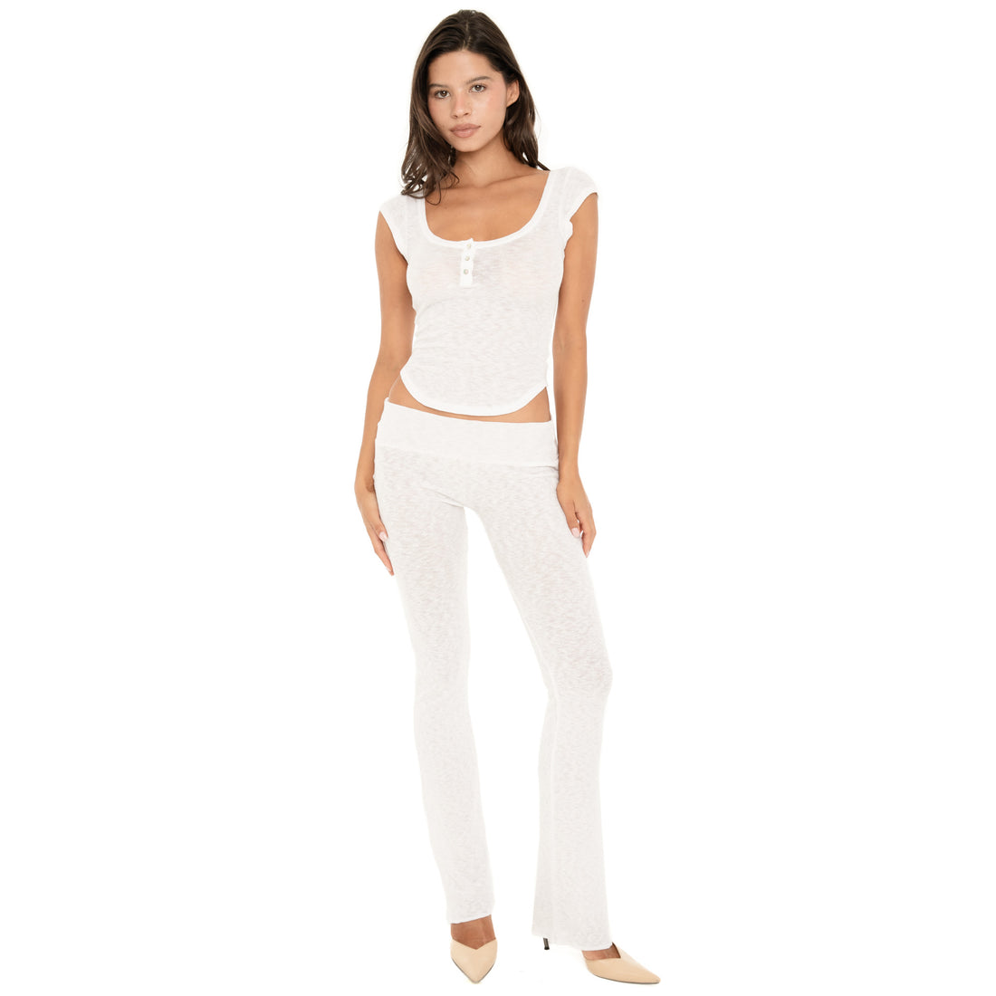 Front angled view of the Illi Pant in White, showing the low-rise fold-over waistband, fitted silhouette through the hips and thighs, and subtly flared leg **white