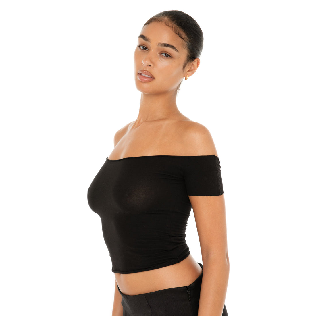 Model wearing the Ilze Top in white, an off-the-shoulder fitted jersey top made of lightweight cotton-spandex blend with raw hems **black