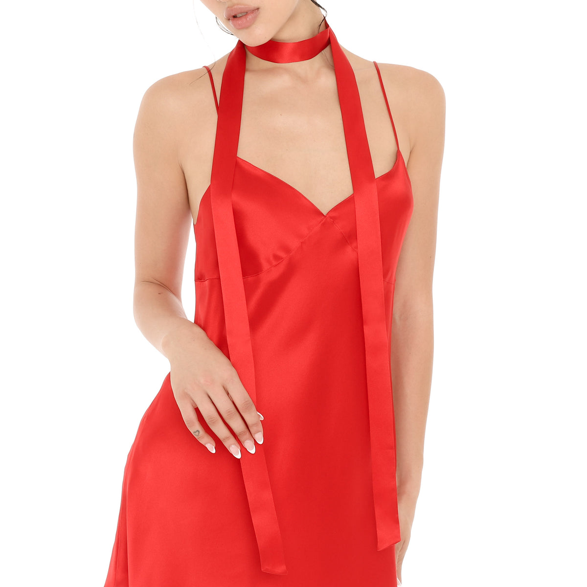 Close-up of the Isolde Scarf in cherry red silk, wrapped once around the neck with both long ends falling down the front of a matching cherry red silk Eisling Dress. **cherry red