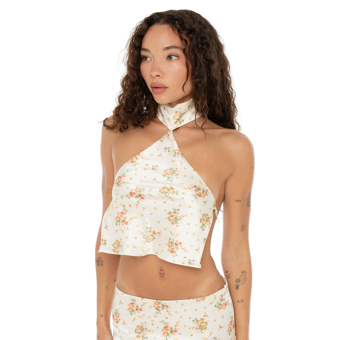 Upper-body close-up of the model wearing the Kiku Top in ivory floral, showing the gathered neckline and print detail. **ivory