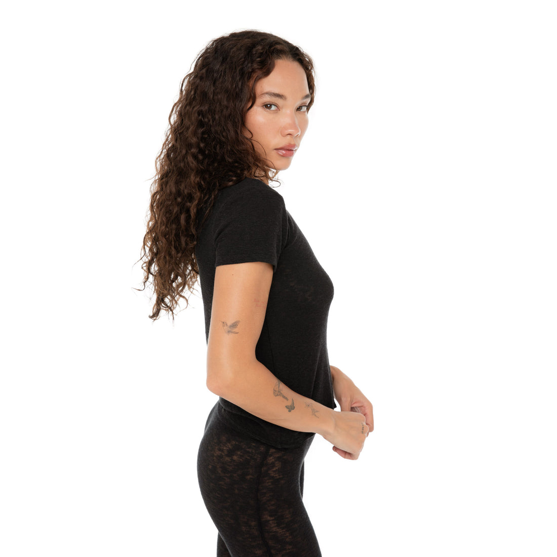 Side profile of Are You Am I Kimi Tee black, lightweight ribbed t-shirt. **black