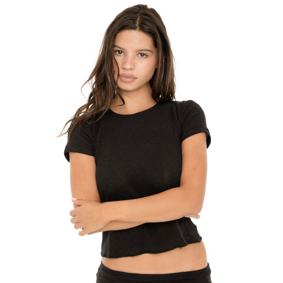 Front close-up of the Kimi Tee in Black, showing the fitted silhouette, crew neckline, short sleeves, and subtly curved cropped hem **black