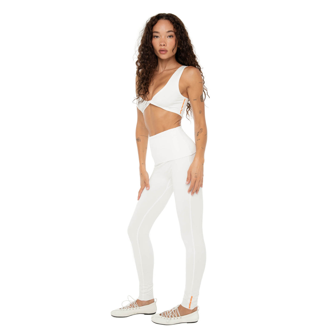 Side angle of Kixa Legging in white showing sleek stretch active fabric. **white