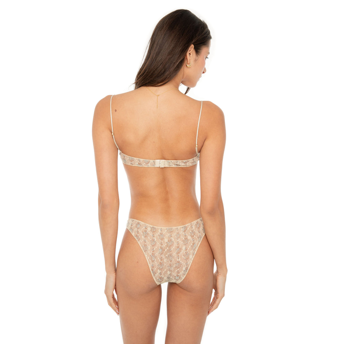 Model wearing the Iselle Bikini in blush floral lace — sheer low-rise brief with scalloped trim and stretch lace for an ultra-light fit.**sky blossom