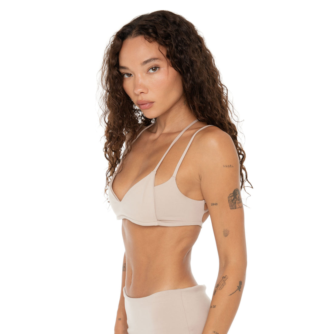 Side profile of Iida Bra in nude showing minimal double strap design. **nude