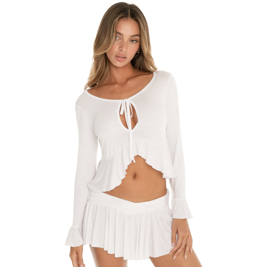 Angled side view of white Lunet top highlighting cropped silhouette and flared sleeve cuffs **white