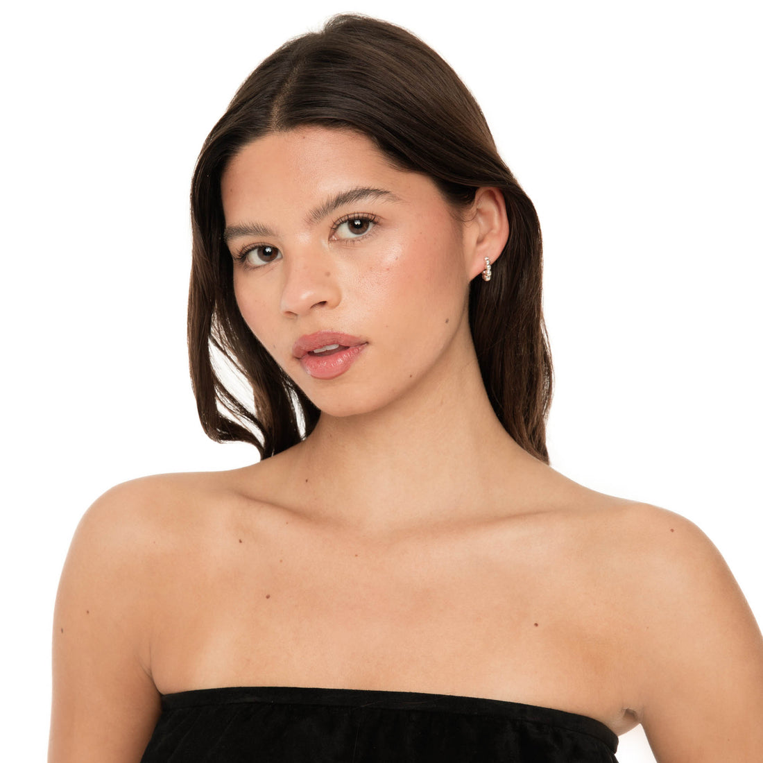 Model wearing Lyth hoop earrings in sterling silver, featuring small polished hoops with a sculptural stacked-bead design.