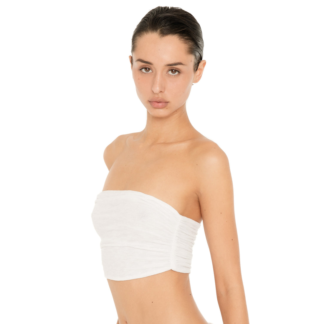 Close front view of model wearing the Meili Bandeau in White, highlighting the strapless neckline and all-over ruched texture. **white