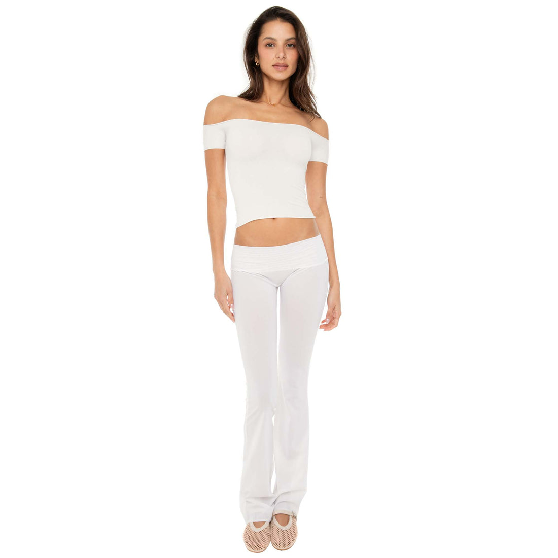 Model wearing the Ilze Top in white, an off-the-shoulder fitted jersey top made of lightweight cotton-spandex blend with raw hems **white