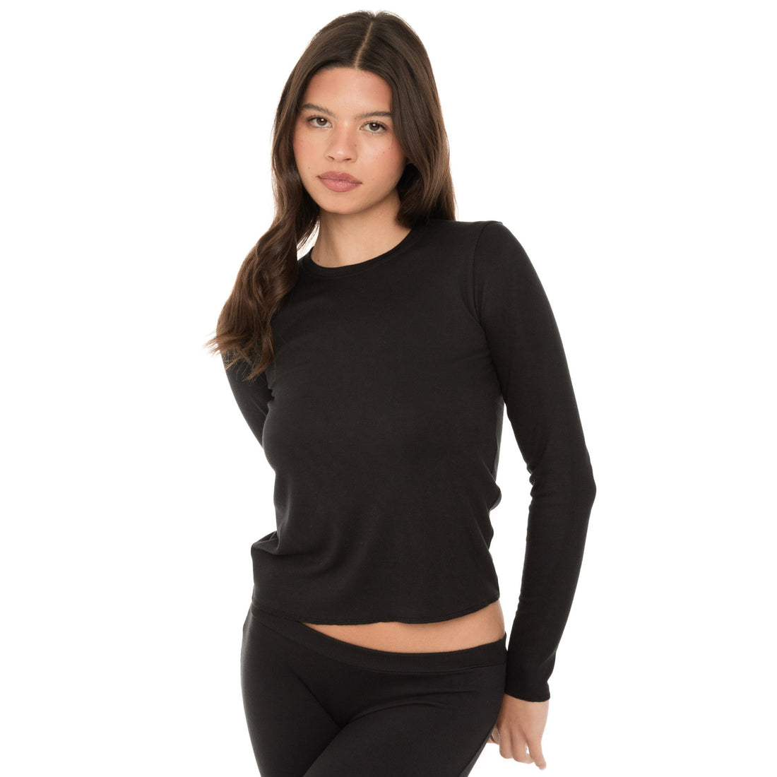 Front angled view of the NIIMA Top in black with exposed overlock hem detail.**black