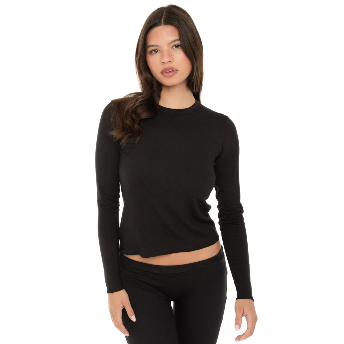 Close-up front view of model wearing the NIIMA Top in black, showing the fitted long-sleeve design.**black
