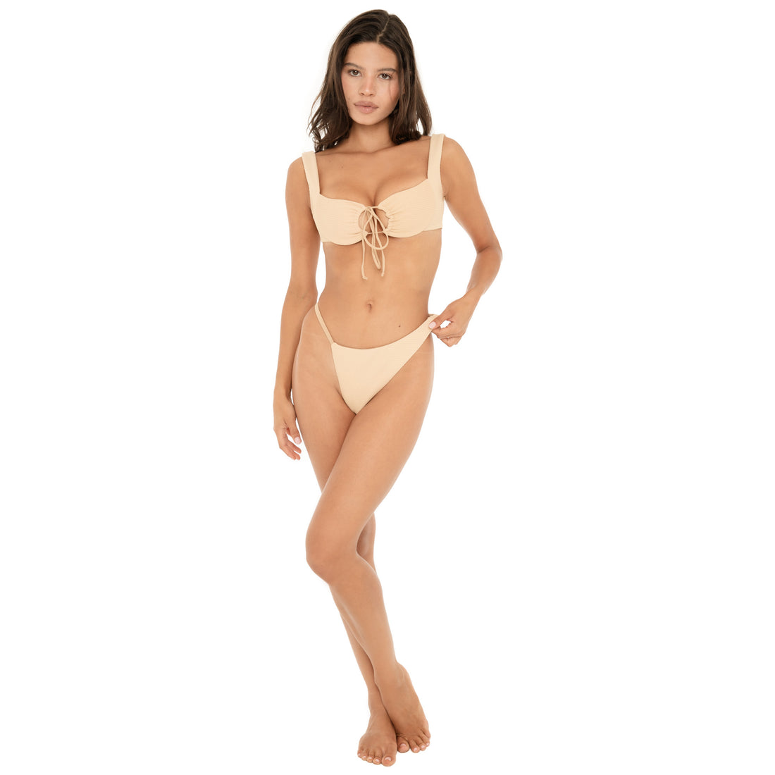 Full-length front view of a model wearing the latte Nou Swim Top with matching bikini bottom. The textured top features wide shoulder straps, gathered cups, and adjustable ties at the center front **latte