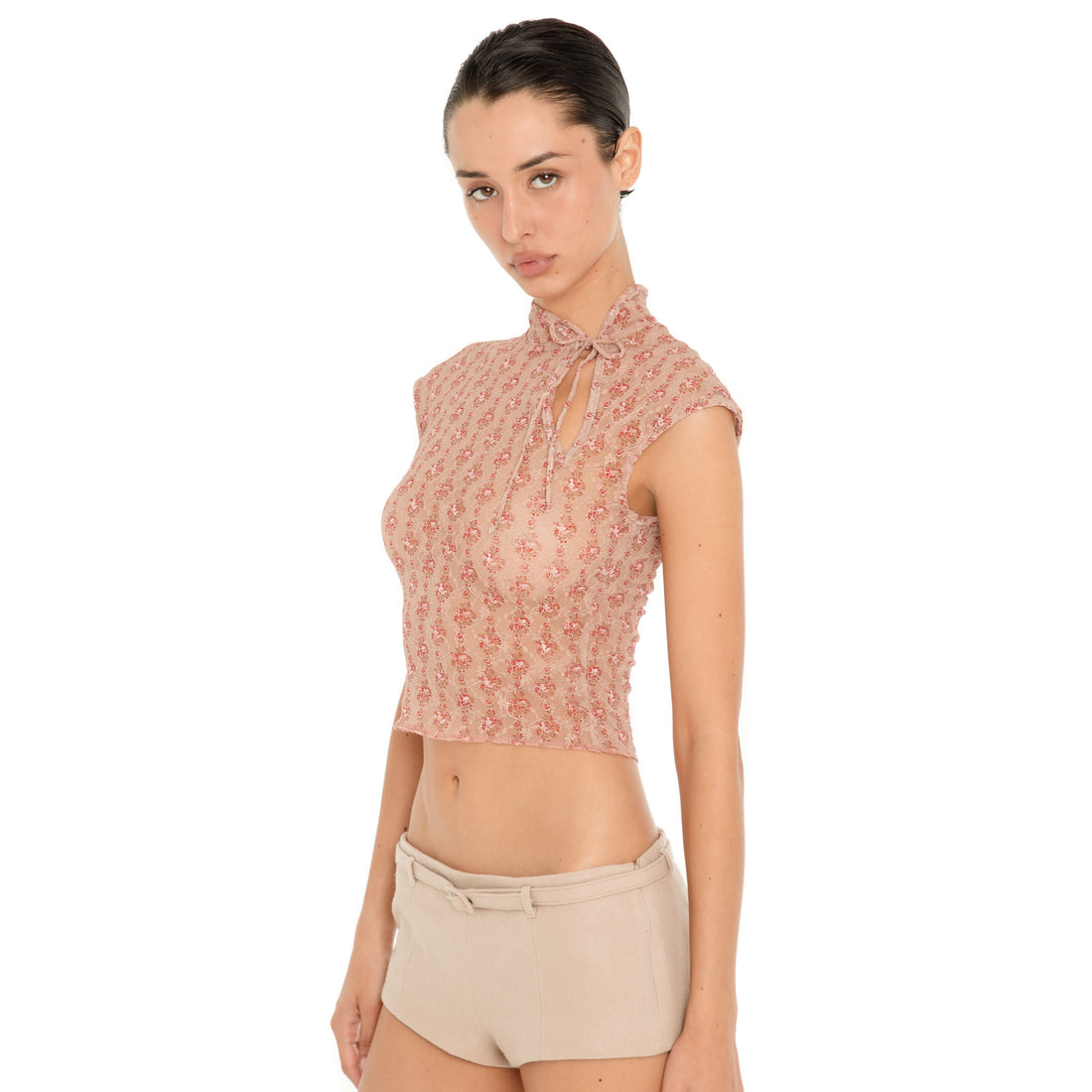 Three-quarter front view of model wearing the Pika Short in Almond, showing the ultra-low-rise fit, fitted silhouette and matching skinny belt. **almond