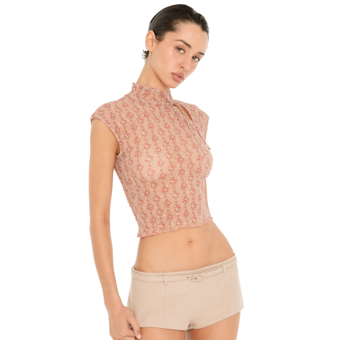 Side three-quarter view of model wearing the Pika Short in Almond, showing the low-rise waist, micro length and fitted silhouette. **almond