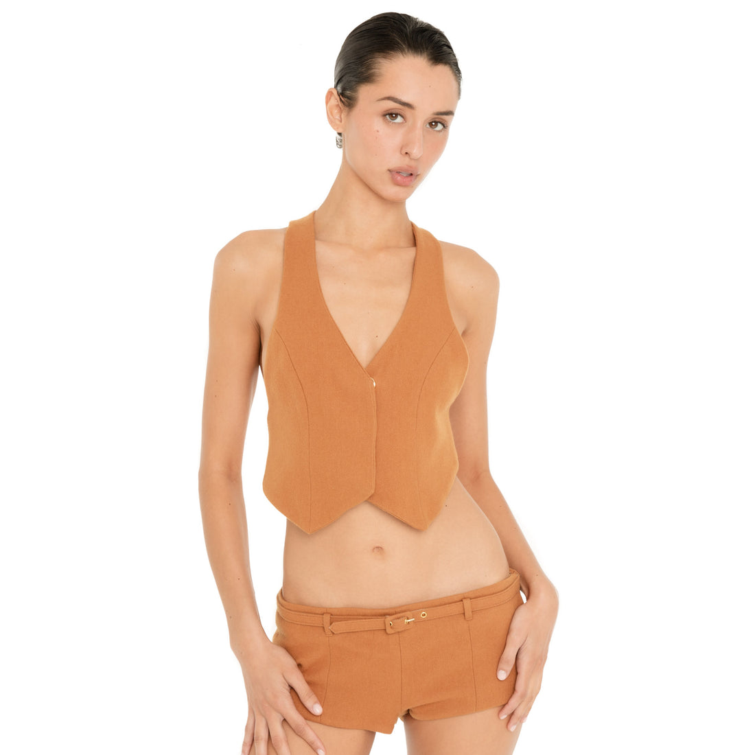 Front three-quarter view of model wearing the Pika Short in Saffron, showing the low-slung fit, micro length and matching skinny belt. **saffron