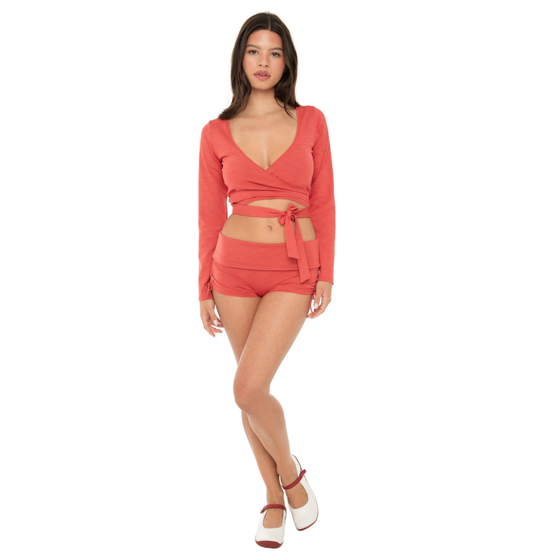 Model wearing the Nuka ribbed wrap top in cayenne with matching low-rise shorts, front view **cayenne