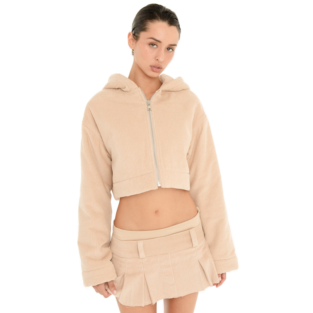 Front view of model wearing the Sfera Jacket in Sand, showing the cropped zip-up silhouette, oversized hood and relaxed long sleeves. **sand