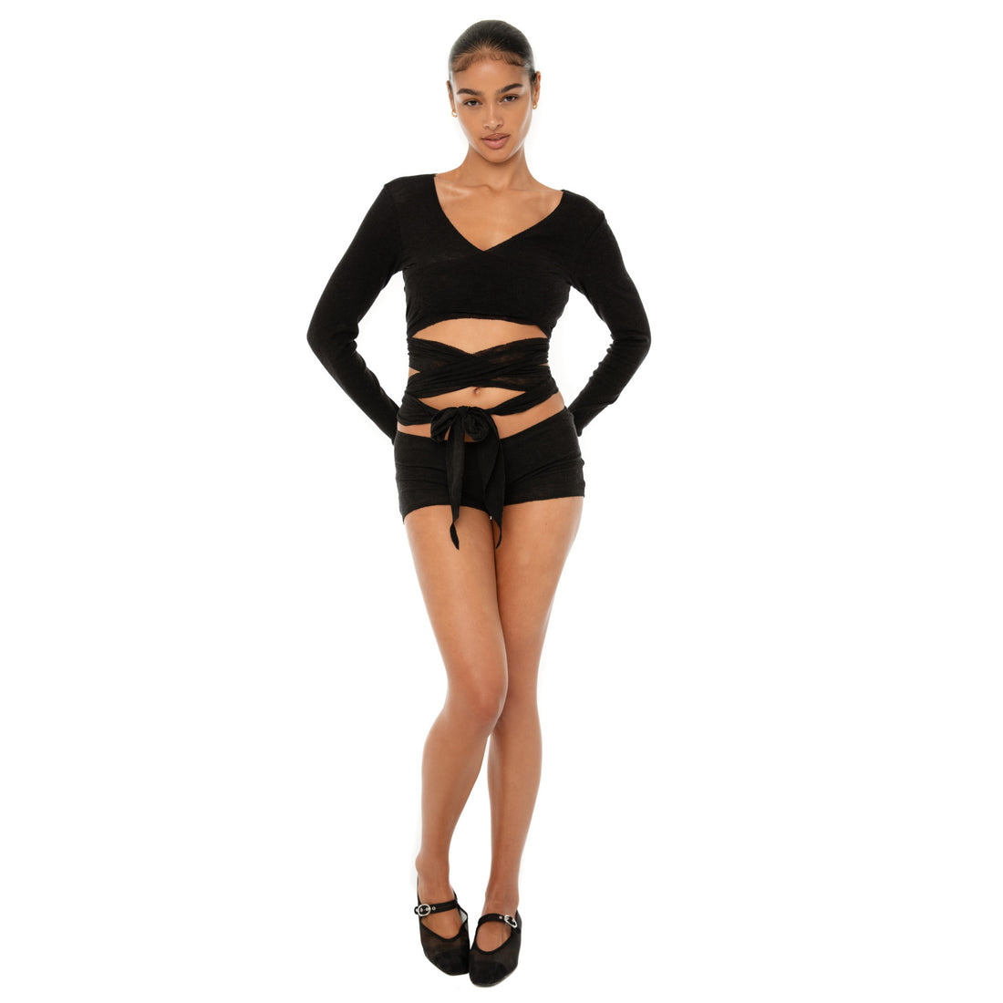 Model wearing the Leili Top — a ballet-inspired wrap top in gauzy tissue rib, offering a barely-there feel with elegant drape.**black