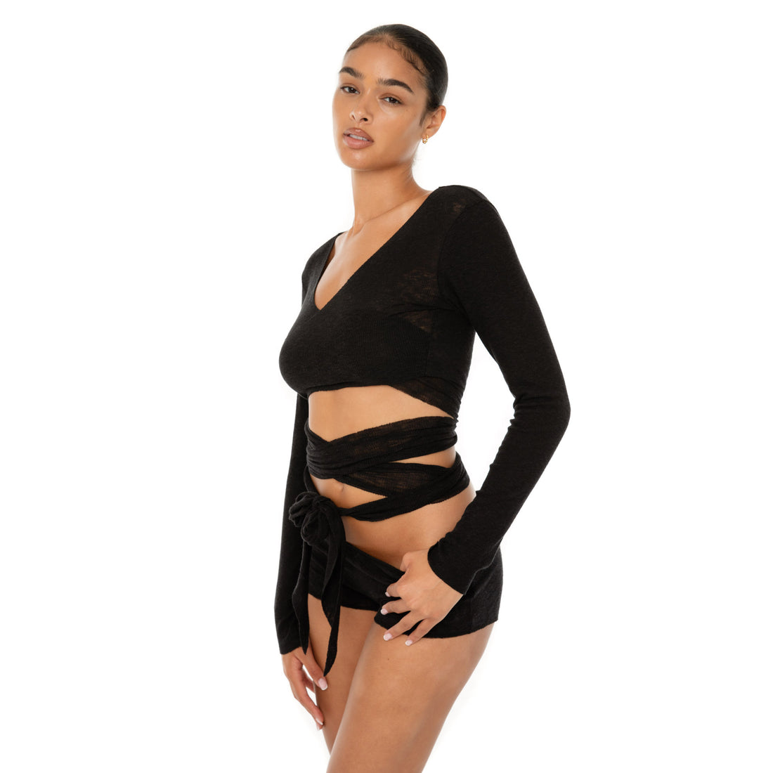 Model wearing the Leili Top — a ballet-inspired wrap top in gauzy tissue rib, offering a barely-there feel with elegant drape.**black