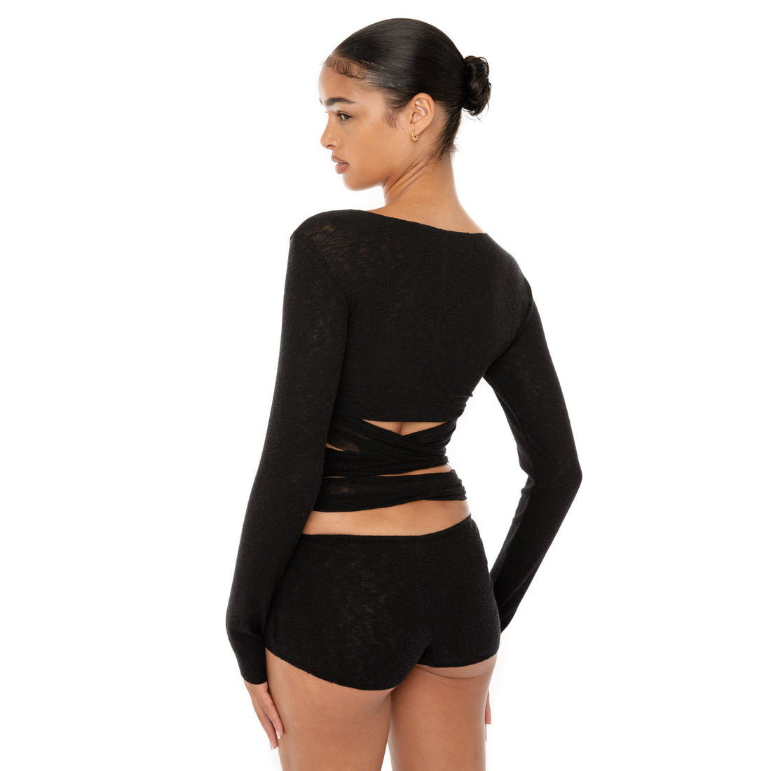 Model wearing the Leili Top — a ballet-inspired wrap top in gauzy tissue rib, offering a barely-there feel with elegant drape.**black