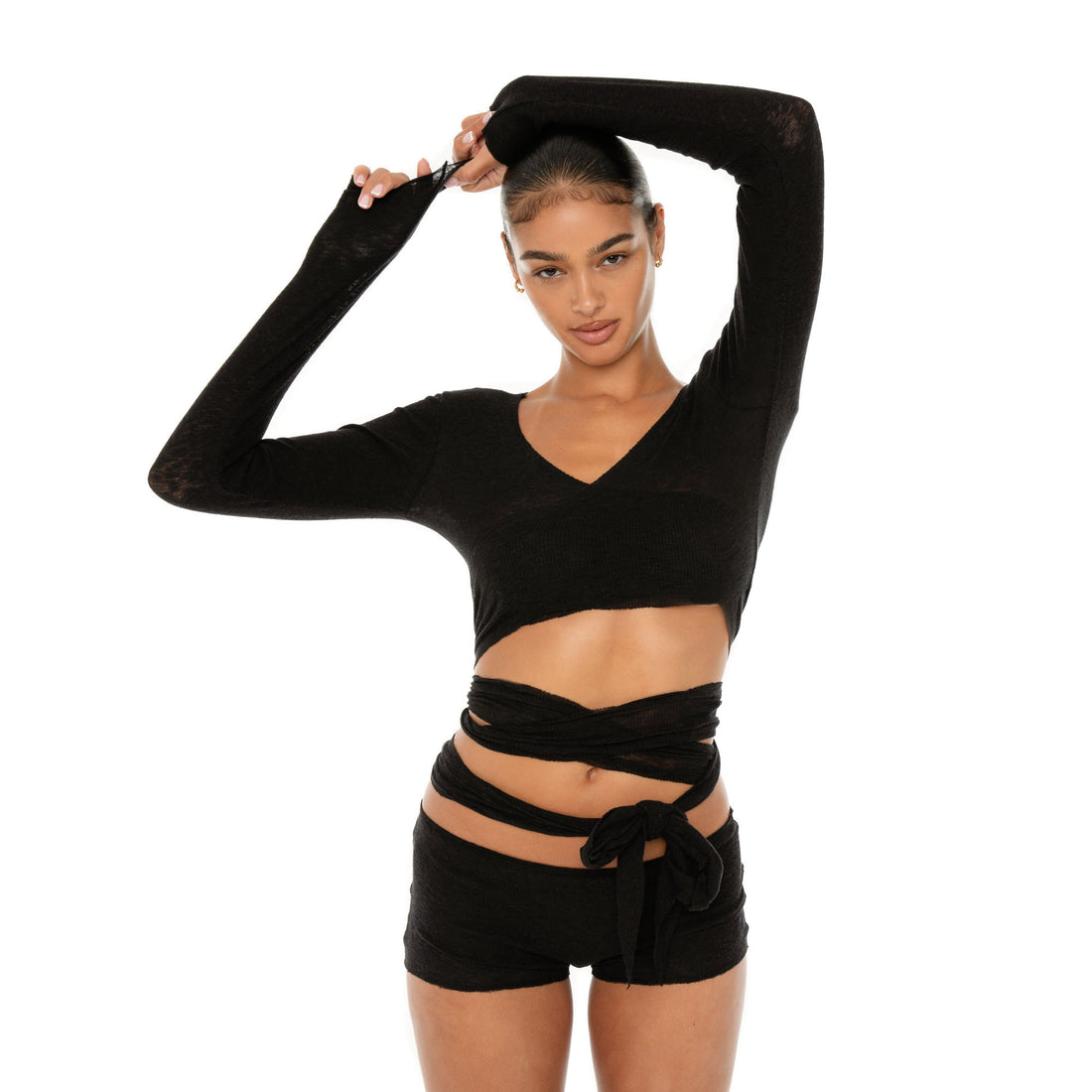Model wearing the Leili Top — a ballet-inspired wrap top in gauzy tissue rib, offering a barely-there feel with elegant drape.**black