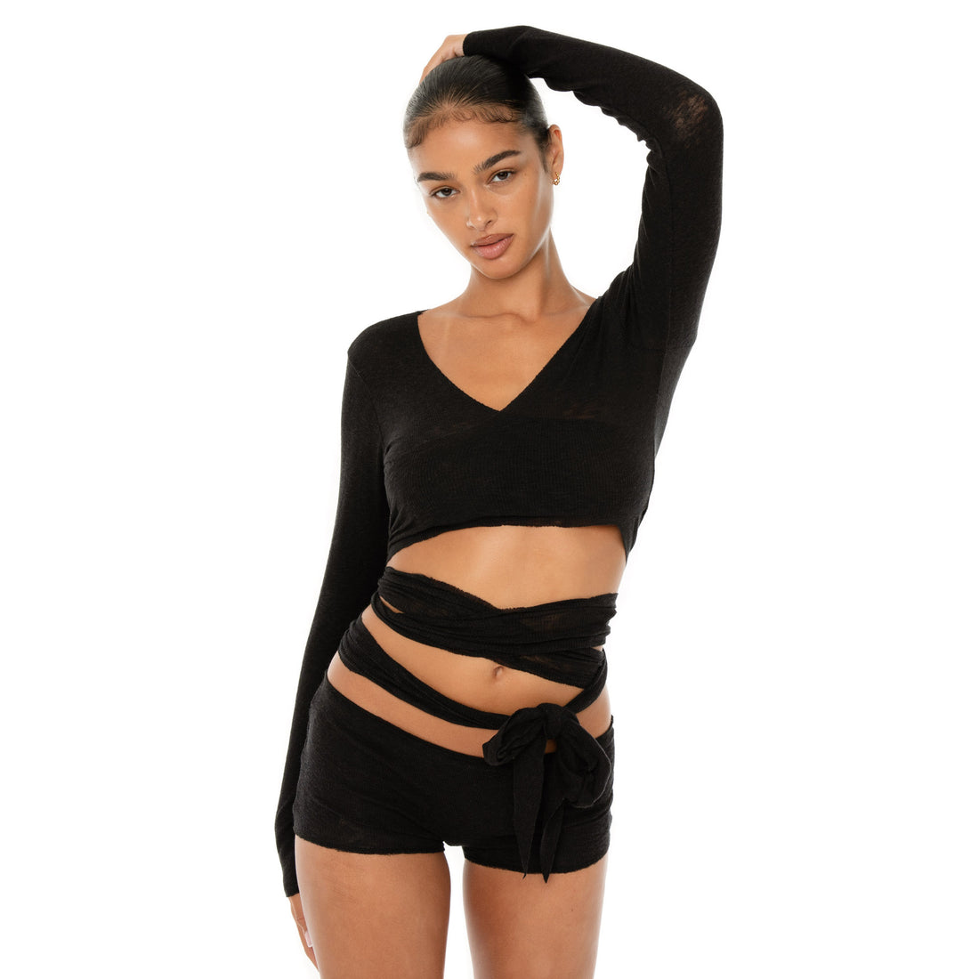 Model wearing the Leili Top — a ballet-inspired wrap top in gauzy tissue rib, offering a barely-there feel with elegant drape.**black