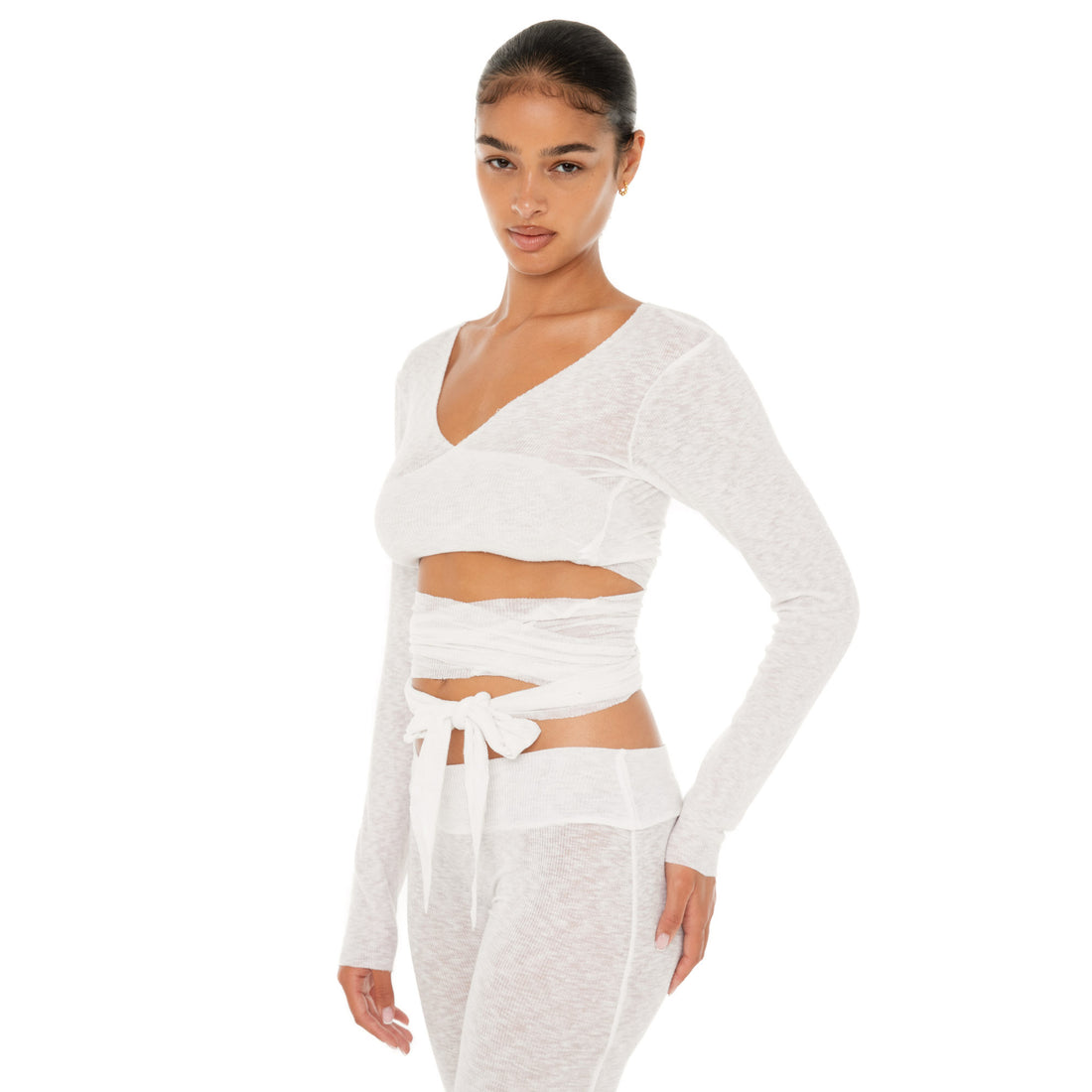 Model wearing the Leili Top — a ballet-inspired wrap top in gauzy tissue rib, offering a barely-there feel with elegant drape.**white