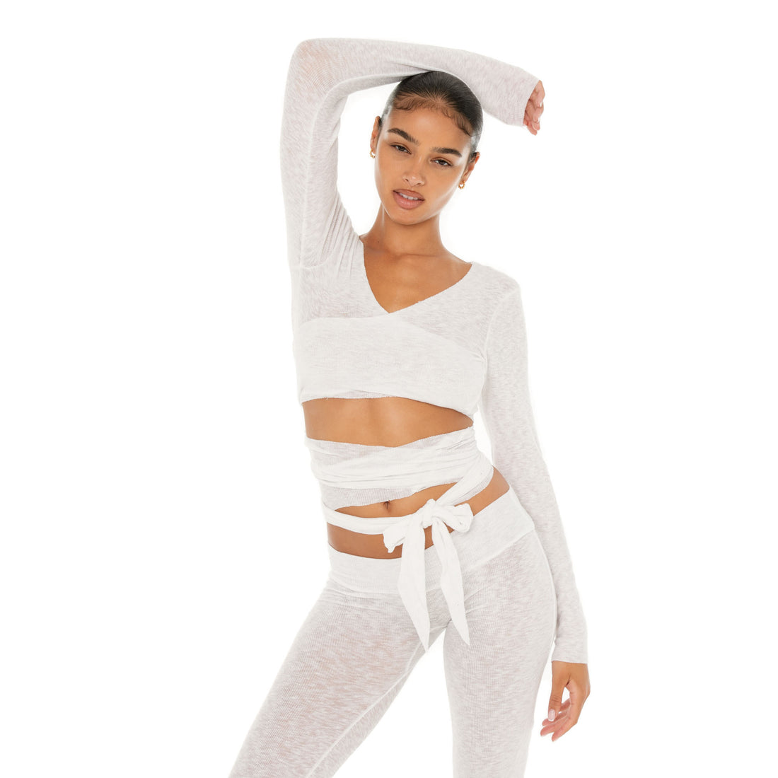 Model wearing the Leili Top — a ballet-inspired wrap top in gauzy tissue rib, offering a barely-there feel with elegant drape.**white