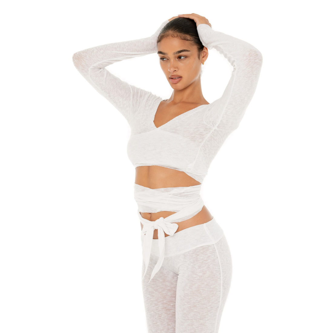 Model wearing the Leili Top — a ballet-inspired wrap top in gauzy tissue rib, offering a barely-there feel with elegant drape.**white