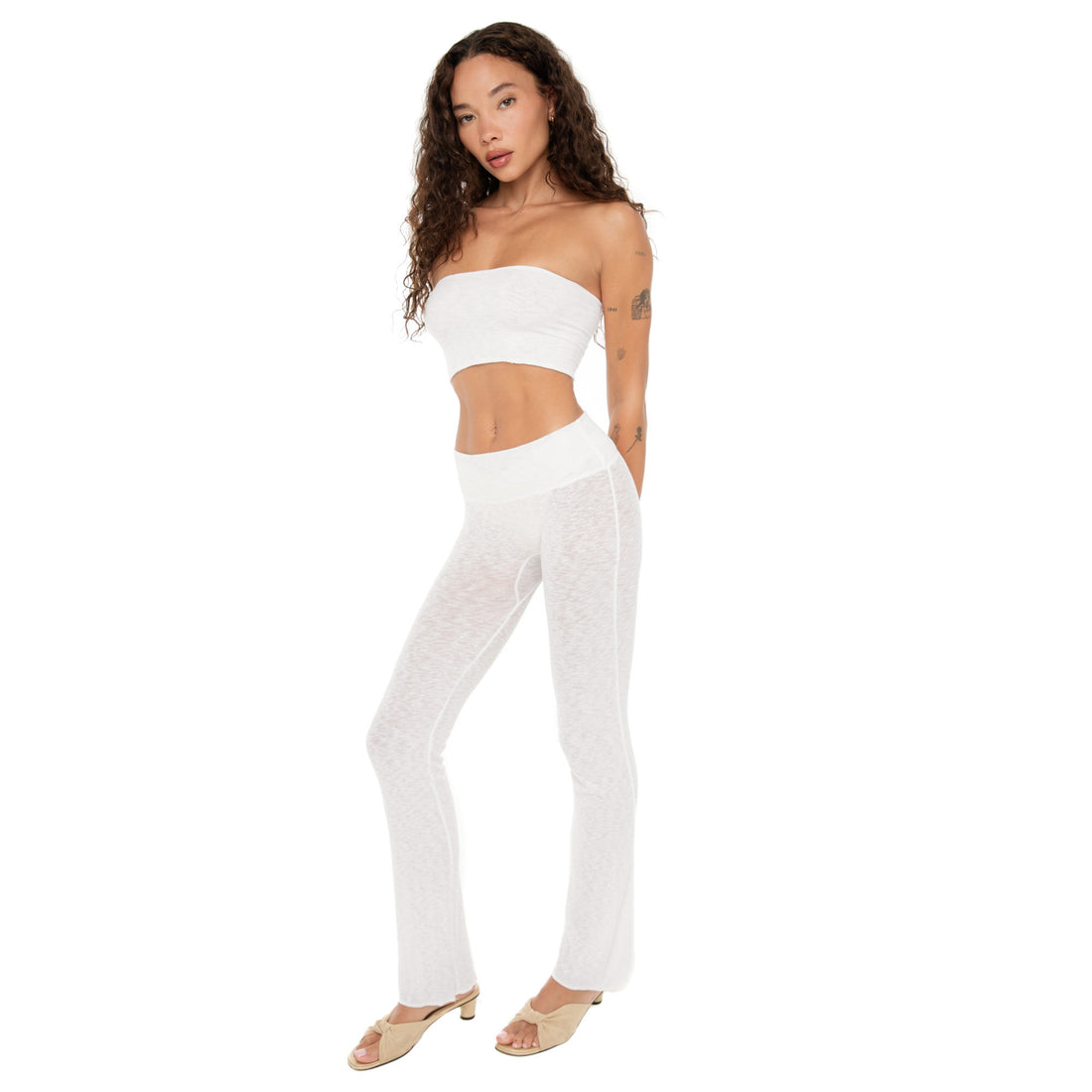 Model wearing the white Aili Tube and matching pants, standing with arms behind her back. **white