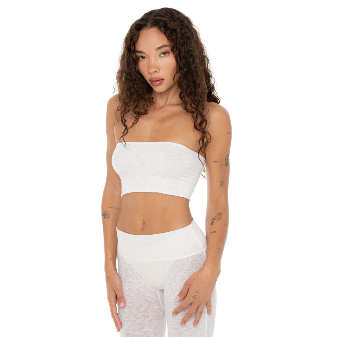 Close-up of the model wearing the white Aili Tube from the front, showing ribbed detail. **white
