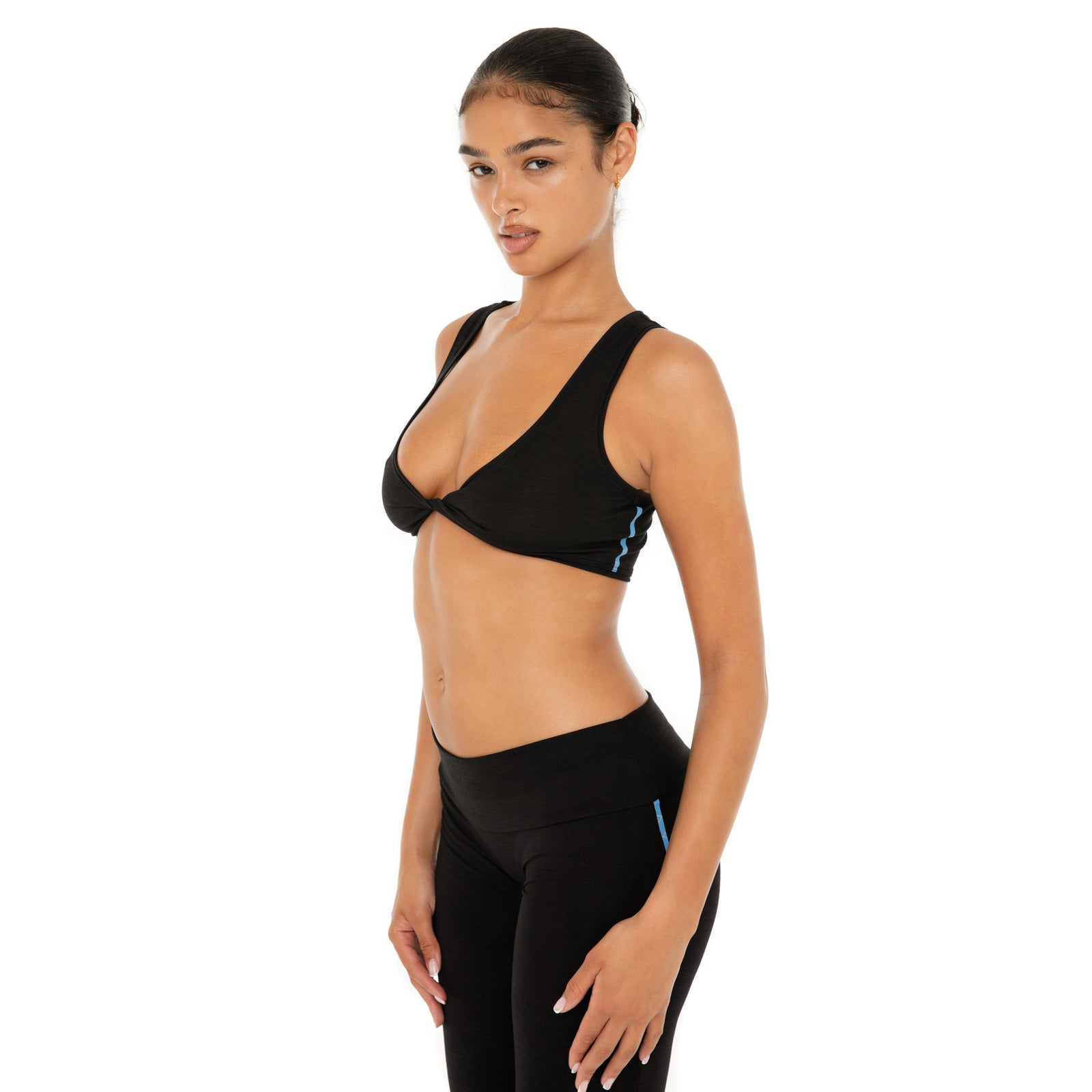 Side view of Alue Top in black showing contoured fit and active ribbed texture **black